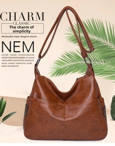 Detail view of vintage brown crossbody bag with leather texture and zip side pockets
