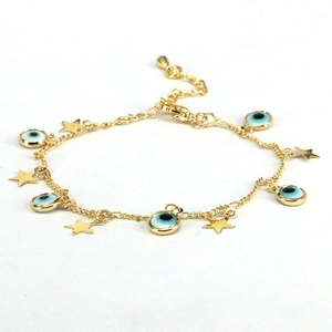 Gold star and blue evil eye charm bracelet with bohemian style on a clean white background
