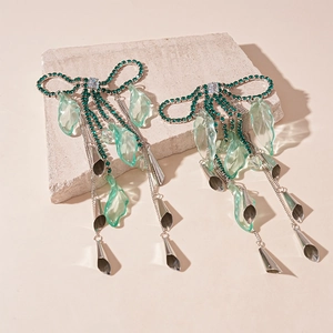 Sparkling crystal bow and mint green petal earrings with silver tassel fringe drop
