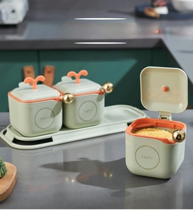 Detail of creative kitchen seasoning box set with sprout lid handles and gold spoons