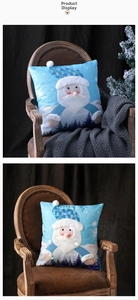 Detail showing Santa Claus Christmas pillowcase with LED lights on a vintage wooden chair