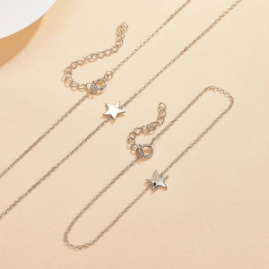 Detailed macro view of S925 sterling silver star necklace and bracelet set with charms