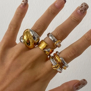 Close-up of mixed metal stackable rings with gold and silver finish on hand