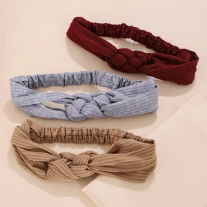 Three knitted twisted headbands in burgundy, grey, and khaki colors with elastic band