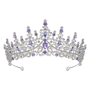 Detail of silver crown with purple teardrop gemstones and sparkling rhinestones