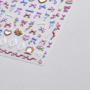 3D embossed nail stickers featuring colorful bows, hearts, and a cute pink rabbit
