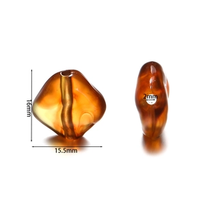 Macro shot of 16mm amber irregular acrylic beads with precise hole dimensions
