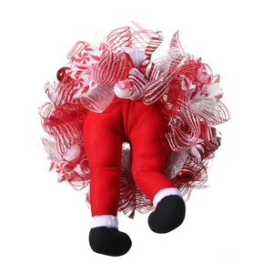 Detail of Christmas wreath featuring Santa legs with red velvet and white plush trim