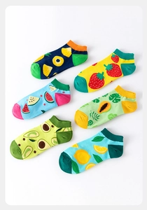 Flat lay of six pairs of low cut ankle socks with colorful fruit patterns on white background