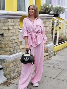 Pink drawstring long sleeve shirt and wide-leg trousers set shown in a street style view