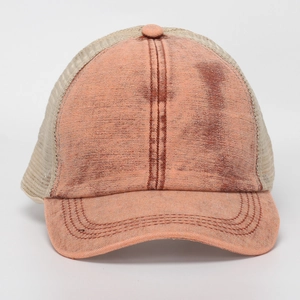 Close-up of vintage washed trucker hat featuring rust red front and beige mesh back detail