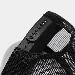 Detail of adjustable black snapback closure and breathable mesh on baseball cap