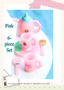Close-up of pink 6-piece miniature resin dollhouse tea set with strawberry patterns
