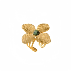 Golden flower ring with green stone in clover shape made of polished stainless steel