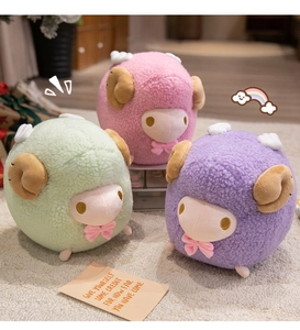 Detailed view of three pastel plush sheep toys with wings on a soft carpet