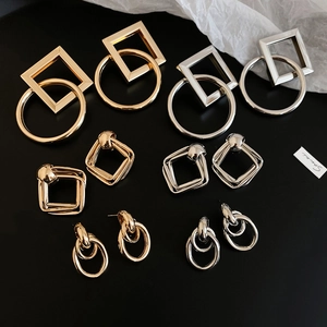 Polished gold and silver geometric earrings in interlocking square and round shapes