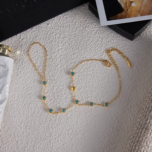 Detail der vergoldeten Edelstahl-Handkette mit blauen Türkis-Steinen für Damen