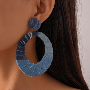 Denim fabric hollow oval hoop earrings with silver needle shown on model