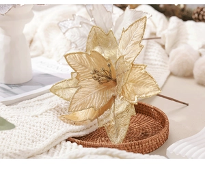Detail of champagne gold artificial poinsettia with glitter texture for Christmas tree decor