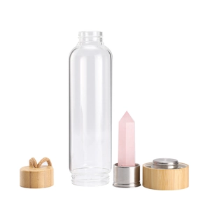Disassembled glass water bottle featuring pink crystal pillar and natural bamboo lids