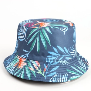 Detail of tropical palm leaf print and orange flowers on navy bucket hat with stitched brim