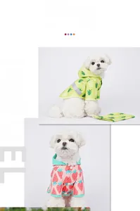 Detail of waterproof dog raincoats with cute pineapple and strawberry fruit print patterns