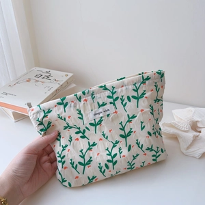 Detailed texture of cotton makeup bag featuring floral prints and simple wish woven label