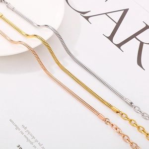 Detailed view of silver, gold, and rose gold snake bone bracelets with lobster clasps