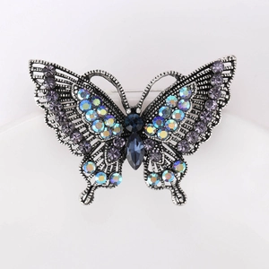 Detailed macro view of vintage silver butterfly brooch with colorful crystals