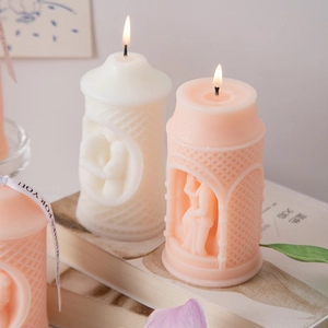 Macro shot of sculptural pillar candle featuring couple embrace relief and grid texture