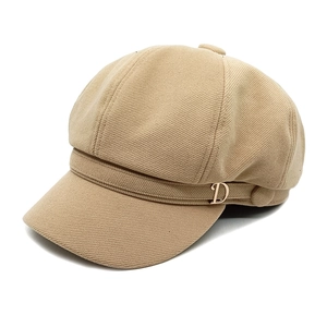 British style light khaki newsboy cap with gold D-buckle detail on white background