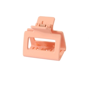 Close-up of a pink square matte hair claw clip with a durable spring on white background
