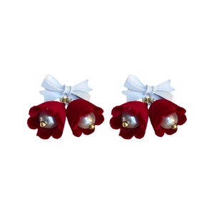 Bowknot earrings with red flocked flowers and pearls displayed on white background