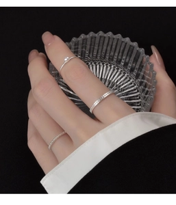 Close-up of s925 silver rings set with freshwater pearl and woven texture on model fingers