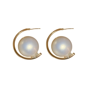 French vintage golden C-shape hoop earrings with large lustrous pearl inserts on white background
