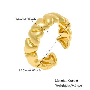 Detail shot of 18K gold plated copper ring with 6.5mm width and textured heart pattern