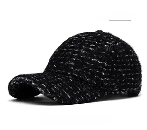 Close-up detail of textured dark gray lamb wool fabric on a warm winter baseball cap