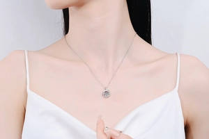Close-up of s925 silver feather necklace with a dancing heart moissanite on neck