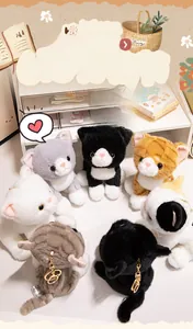Close-up of realistic plush cat keychains in various colors with gold metal rings
