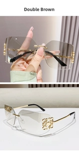 Detail of square rimless sunglasses with brown gradient lenses and gold metal logo temple