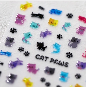 Macro shot of 3D resin cat nail stickers with translucent macaron colors and paw motifs