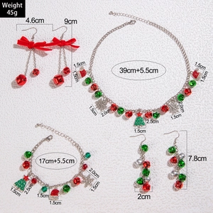 Christmas jewelry set with red and green bells, tree pendants, and velvet necklace ribbon