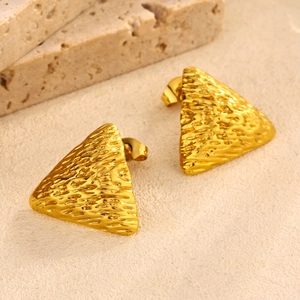 Macro detail of golden triangle stud earrings with textured hammer finish surface