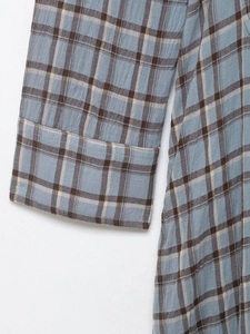 Close-up of blue and brown plaid shirt dress fabric showing breathable cotton texture