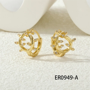 Close-up of gold-plated leaf-shaped hoop earrings with micro-set zircon stones