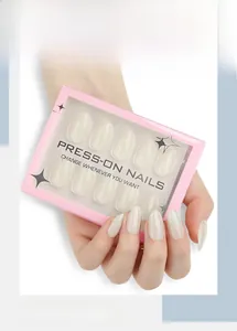Detail of minimalist cream white almond press-on nails in elegant window box packaging