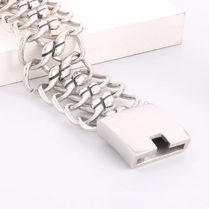 Macro shot of silver woven mesh link bracelet with industrial square buckle design