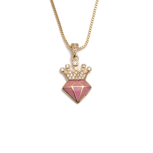 Detail of gold crown pendant with pink enamel heart and shimmering cubic zirconia stones