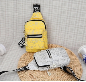 Detail of crossbody chest bag with graffiti print and wide adjustable shoulder strap