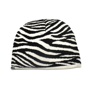 Detailed view of the soft knitted texture and black and white zebra print on the beanie hat